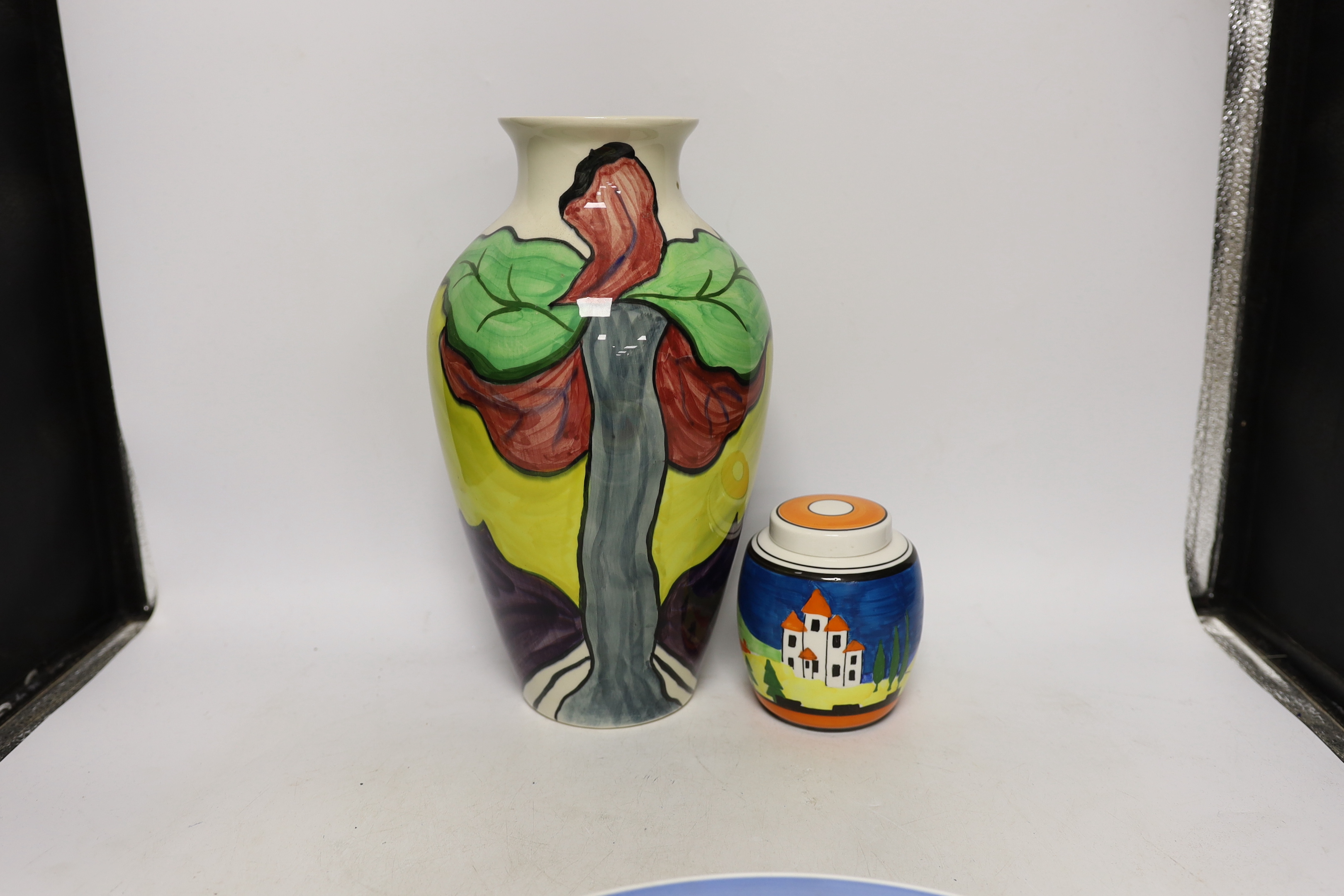 Four Clarice Cliff style plates, a similar vase and a jar and cover, tallest 31cm